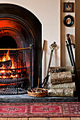 Chestnuts roasting by an open fire in Walberton home, West Sussex, England, UK