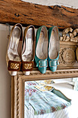Vintage shoes on mirror frame with timber beam in Hertfordshire home, England, UK