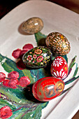 Decorative Easter eggs on hand-painted tray in Essex home, England, UK