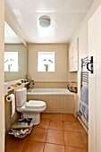 Tiled cream bathroom in Suffolk farmhouse, England, UK
