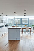 Kitchen island in white fitted kitchen of Wadebridge home, Cornwall, England, UK