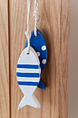 Two blue and white fish hang on string in Wadebridge home, Cornwall, England, UK