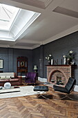 Black Barcelona chair in living room with parquet flooring and lightwell, London home, England, UK