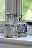 Handpainted ceramics on windowsill in contemporary Suffolk/Essex home, England, UK