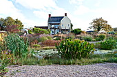 Rural farmhouse with garden pond in Blagdon, Somerset, England, UK