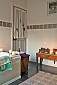 Lit candles and laundry basket in bathroom detail of Tregaron home Wales UK