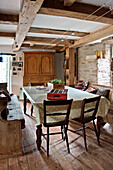 Dining table and chairs with spotted tablecloth in Sherford barn conversion Devon UK