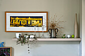 Framed artwork with ornaments on shelf in living room of East Grinstead home West Sussex England UK