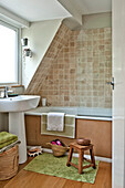 Tiled bathroom with pedestal basin East Grinstead family home West Sussex England UK