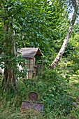 Wooden garden shed with vintage roller in East Grinstead garden Sussex England UK