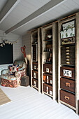 Vintage storage units with armchair and large scissors in Stamford home Lincolnshire England UK