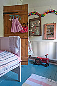 Toy tractor in girls room of Cambridge cottage England UK