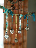Glass baubles hang on ribbon in London home England UK