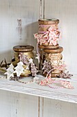 Vintage wooden spools with cut Christmas tree shapes on shelf in London home England UK