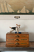 Dog ornament on wooden drawrs with sailing boat artwork in Penzance farmhouse Cornwall England UK