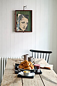 Croissants and jam with framed artwork in family townhouse Cornwall England UK