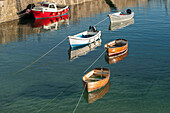 Boats moored in Mousehole harbour Cornwall UK