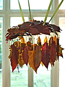 Autumn leaf mobile hung with ribbons in UK home