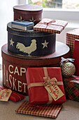 Gift wrapped Christmas presents and hatbox in Penzance farmhouse Cornwall UK