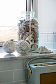 Seashells and baubles on windowsill with vintage radio in Penzance home Cornwall UK