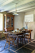 Holzstühle und Kommode mit Tisch für den Nachmittag in der Küche eines Bauernhauses in Helston, Cornwall, Großbritannien