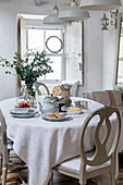 Dining table and chairs with crumpets and jam in Marazion beach house Cornwall UK