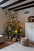 Gift wrapped presents under Christmas tree in St Erth cottage Cornwall UK