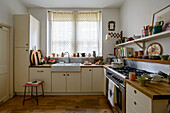 Retro style kitchen with net blinds in London home UK