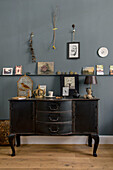 Dried flowers and vintage objects with antique chest of drawers in London home UK