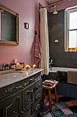 Marble topped wash stand in pink and grey bathroom of London home UK