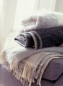 Stack of woolen blankets in living room