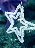 Glass beaded star Christmas decoration on Christmas tree