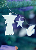 Close up of wooden Christmas tree decorations on a wire