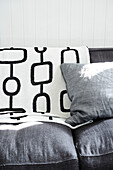 Black and white cushion on grey sofa in Lyme Regis home Dorset UK