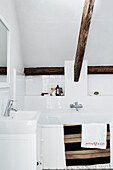 Beamed bathroom with striped mat in Lyme Regis home Dorset UK