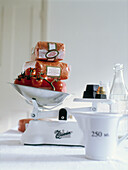 Packets of pulse and tomatoes on old fashioned kitchen scales