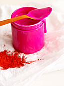 PInk dye on spoon with red powder