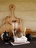 Schnurknäuel mit schwarzer Keramik-Teekanne und Holzschneidebrettern