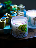 Lit candle and gift wrapped presents