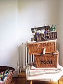 Open hamper with bottles stacked on top of folded linen