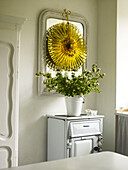 Gold decoration hanging above white flowers on freestanding oven