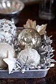 Vintage glass baubles and tinsel on tray