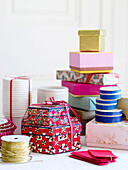 Assorted gift boxes with a spool of gold thread