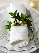 Mistletoe and ivy with linen napkin on side plate