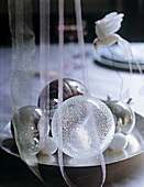 Assorted baubles and ribbon as centrepiece on table