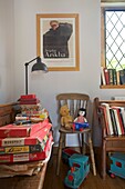 Old fashioned board games with books and soft toys in Cranbrook family home, Kent, England, UK