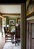 View through doorway to dining room in timber framed cottage, Grafty Green, Kent, England, UK