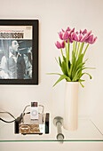 Music dock and cut tulips with framed vintage record cover in Manchester family home, England, UK