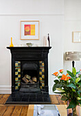 Victorian fireplace and cut lilies in Manchester family home, England, UK
