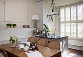 Sunlit kitchen and dining area with plum jam recipe on table in Cranbrook home, Kent, England, UK